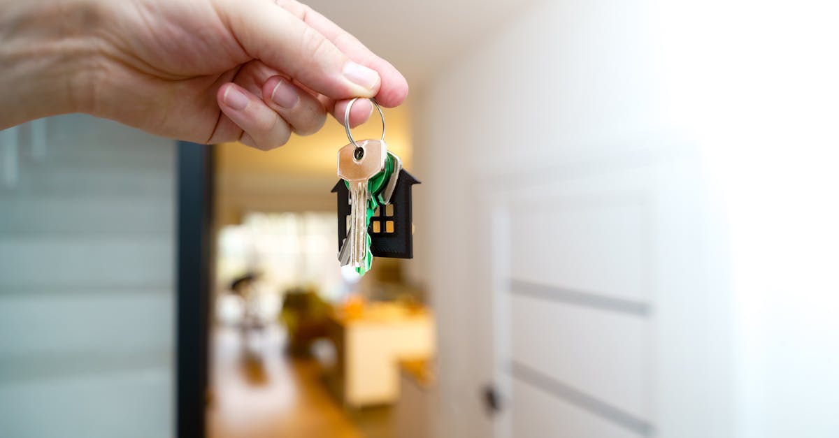 Hand holding keys to first apartment